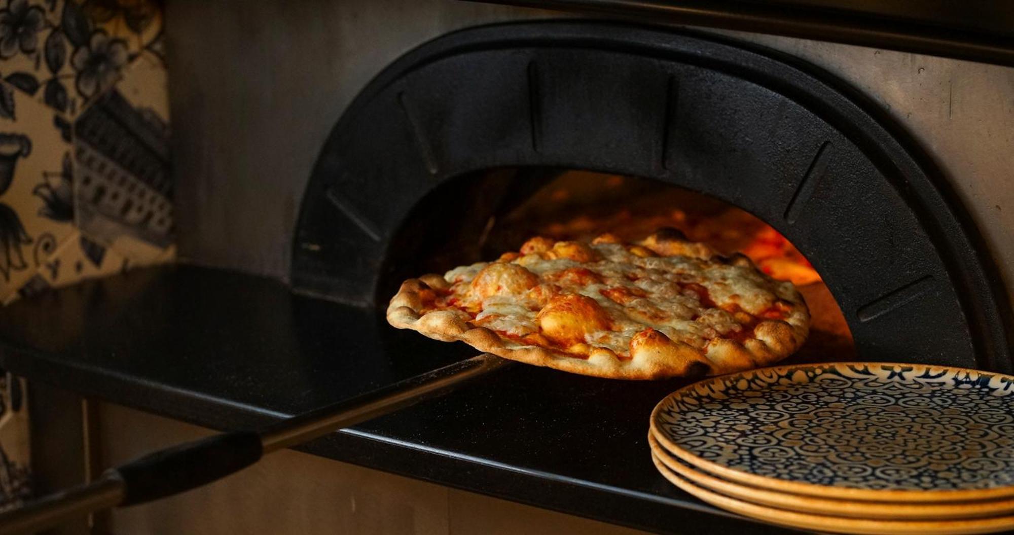 Eme Catedral Mercer Hotel Seville Exterior photo Pizza being removed from a wood-fired oven